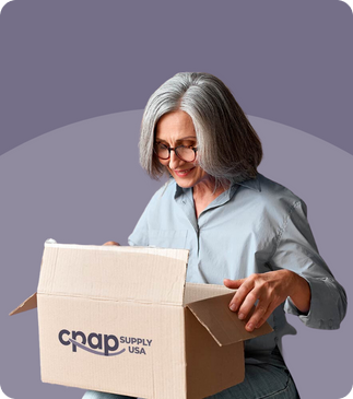 A woman excitedly opens the box containing her order from CPAP Supply USA